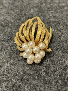 Pearl and Gold Brooch with pin back.  Stamped and tested at 14K Yellow Gold, 9.8 DWT. Set with 11 fine quality cultured pearls 5.4 to 5.8mm in diameter.  Total weight, 15.3 grams, cast and assembled, cast in textured finish, very well made.  Pearls are a very good match, slightly creamy rose' color, overall quality very good to excellent.  All descriptions taken directly from GIA Graduate Gemologist appraisal, and AGS Certified Gemologist Appraiser's appraisals. Elegant Pearl Brooches For Formal Occasions, Gold Pearl Brooches For Wedding, Formal Gold Pearl Brooches, Elegant Gold Brooches With Pearl Pendant, Gold Round Pins For Anniversary, Elegant Pearl Brooches For Evening, Elegant Evening Pearl Brooches, Gold Pearl Brooch Jewelry, Gold Brooch With Pearl Pendant For Wedding