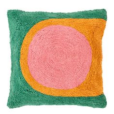 a green and pink pillow with a circular design on it