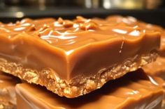 chocolate bars stacked on top of each other with nuts and caramel toppings in the middle