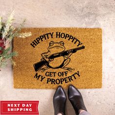 a person standing next to a door mat that says happy hoppity get off my property