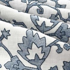 blue and white fabric with flowers on the bottom, as well as an image of leaves