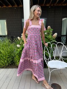 This is it! THE dress of the summer! Meet Maisie, our newest cotton block print maxi dress in a Pink Posey print. She’s full of sweet details like a tiered skirt, and contrasting striped banding. The bow straps are adjustable for the perfect fit, and it features a smocked back panel for comfort. Did we mention it has POCKETS!? Whether you're sipping lemonade on the porch or hitting up a summer wedding or soirée, this dress is a fun, versatile addition to your closet. Throw it on with sneakers or Tiered Cotton Maxi Dress For Garden Party, Cotton Maxi Dress With Tie Straps, Cotton Tiered Skirt Dress For Garden Party, Cotton Tiered Skirt Maxi Dress For Garden Party, Cotton Tiered Maxi Dress For Garden Party, Cotton Maxi Dress With Tiered Skirt For Garden Party, Printed Cotton Maxi Dress For Day Out, Cotton Dress With Tie Straps And Tiered Skirt, Cotton Tiered Maxi Dress For Beach