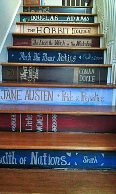 some books are stacked on top of each other in front of the stair railings