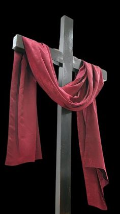 a cross with a red scarf draped around it