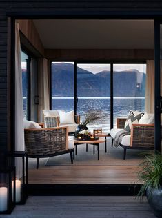 two wicker chairs sitting next to each other on top of a wooden floor