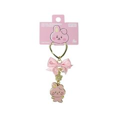 a pink key chain with a cartoon character on it's side and a bow tie around the neck