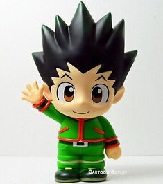 a toy figurine with black hair and green clothes on it's head