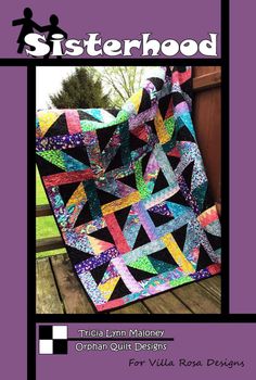 a quilt book with the title sisterhood, which features an image of a black and purple