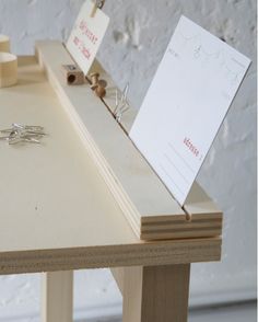 a wooden table topped with lots of crafting supplies