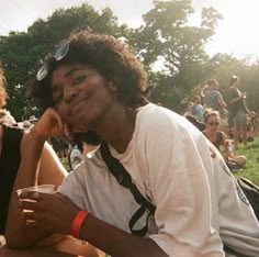 two people sitting next to each other at a park