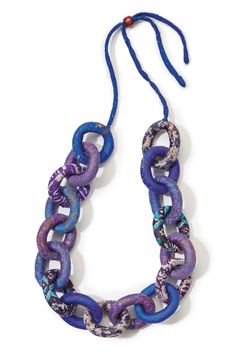 a blue and purple necklace with an oval link hanging from it's center, on a white background