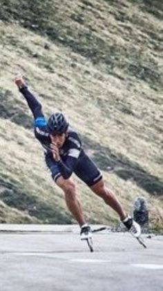 a man riding a skateboard down the side of a road