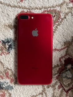 an apple phone is laying on the carpet