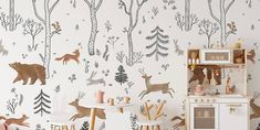 the wall paper has deer and trees on it