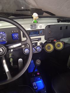 the interior of a car with various electronic devices on it's dash board and steering wheel