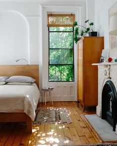 a bedroom with hardwood floors and white walls