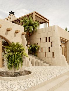 a house that is made out of concrete and has palm trees in the front yard