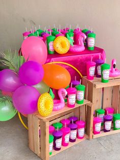 there are many balloons and condiments on the table for this birthday party decoration