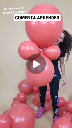 a woman is holding balloons in front of her face and the caption reads, comenta apprender