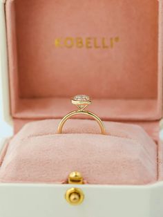 an engagement ring in a pink box with the name kobelli written on it