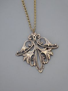 "Vintage Jewelry - Art Nouveau Necklace - Vintage Necklace - Vintage Brass Necklace - French Brass Necklace - Chloe's Vintage Jewelry This is such an exquisite vintage necklace! A gorgeous, graceful floral leaf design. Wonderful warm patina and detail. So very feminine Chloe says, \"Wear it and feel fabulous!\" The pendant measures 2 1/4\" long and 2\" wide. You can choose the necklace length you would like at checkout. Thanks for visiting Chloe's" Ornate Bronze Necklace As Gift, Ornate Bronze Necklace For Gifts, Ornate Bronze Necklace For Gift, Antique Gold Jewelry With Large Pendant As Gift, Antique Gold Large Pendant Jewelry Gift, Artistic Jewelry With Intricate Design For Gift, Art Nouveau Necklace With Intricate Design For Gift, Decorative Antique Gold Necklaces For Gifts, Decorative Antique Gold Necklace For Gift