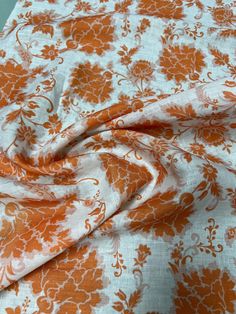 an orange and white floral print fabric