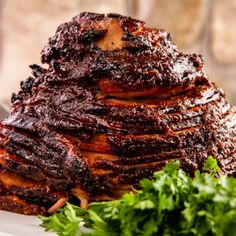 a large piece of meat sitting on top of a plate next to some parsley