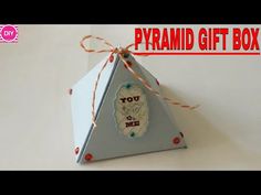 an origami pyramid shaped gift box with the words you & me on it