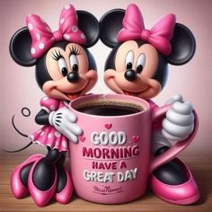 two mickey and minnie mouse figurines holding a coffee cup with good morning have a great day written on it