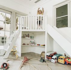 a child's room with stairs and toys on the floor