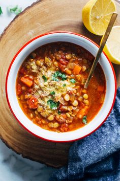 a bowl of soup with chickpeas, carrots and spinach in it