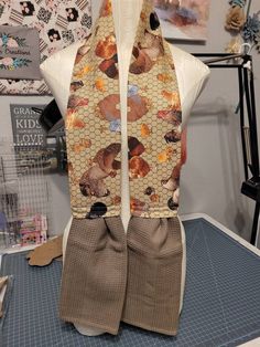 a mannequin wearing a scarf with dogs and flowers on it's sides