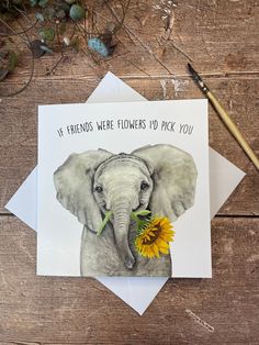 a card with an elephant holding a flower