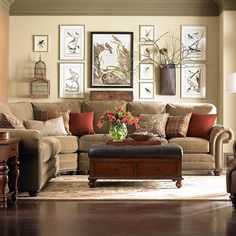 a living room filled with lots of furniture and pictures on the wall above it's coffee table