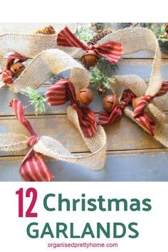 christmas garlands with bells and pine cones tied to them on top of a wooden table