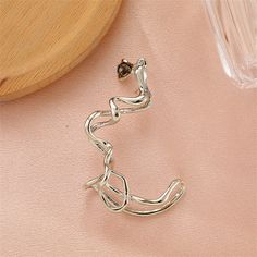 This stylish ear cuff crafted with crystal and a silver-plated finish completes any look. 1.18" W x 2.36" L Silver-plated copper / crystal Cartilage Ear Cuff, Avant Garde Jewelry, Ear Cuff Earings, Spiral Earrings, Gold Cuffs, Girls Earrings, Cuff Earrings, Water Drop, Drop Pendant