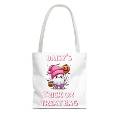 a white tote bag with an image of a cat wearing a pink hat and pumpkins