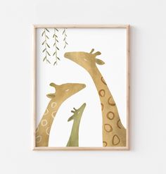 two giraffes are standing next to each other in front of a white wall