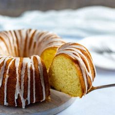 a bundt cake on a plate with a slice cut out and ready to be eaten