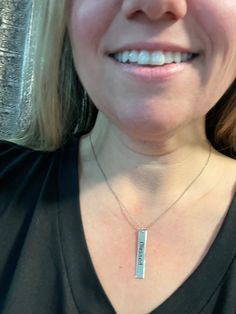 A silver bar saying the word blessed. 16” long necklace.