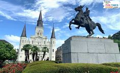 a statue of a man riding a horse in front of a church with spires