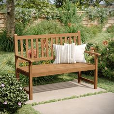 a wooden bench sitting in the middle of a garden