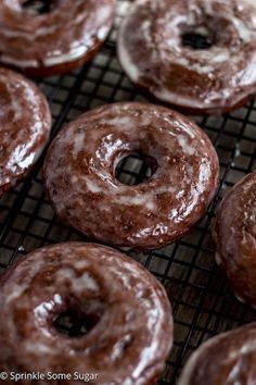 chocolate donuts cooling on a wire rack