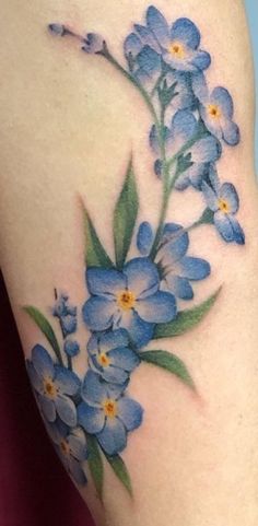 a blue flower tattoo on the right thigh