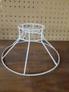 a white wire basket sitting on top of a wooden table