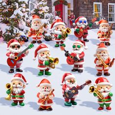 a group of santa claus figurines playing instruments and singing in front of a christmas tree