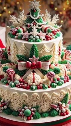 a three tiered christmas cake decorated with candy canes and candies on top