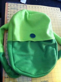 a green bag sitting on top of a cutting board