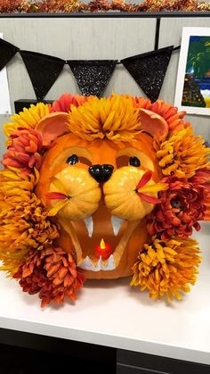 a lion head made out of fake flowers