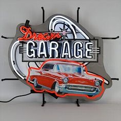 an old red car is on display in front of the garage sign that says dream garage